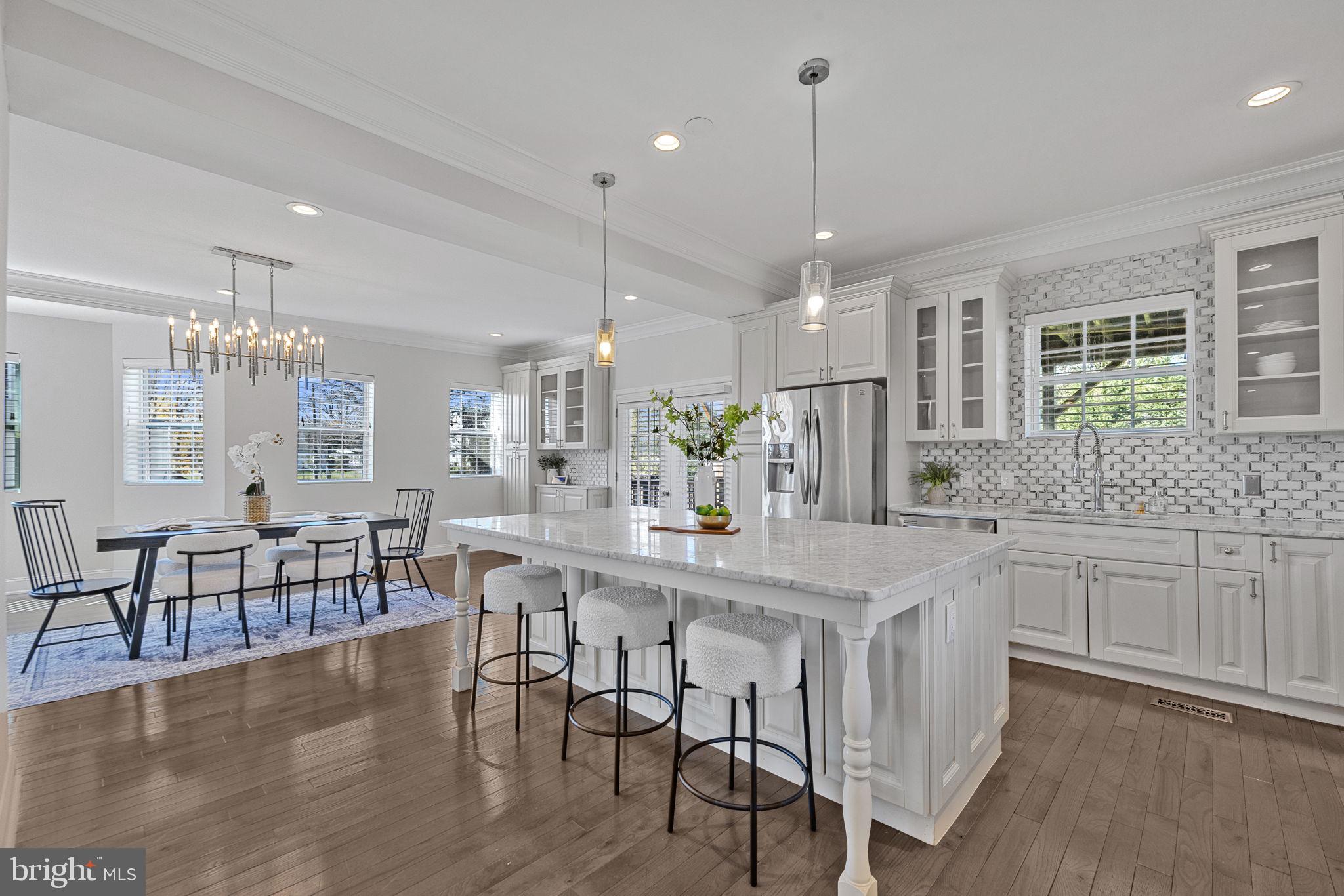 2420 West Rogers Avenue Baltimore, MD 21209 - Photo 4 of 67 a kitchen with center island table and chairs