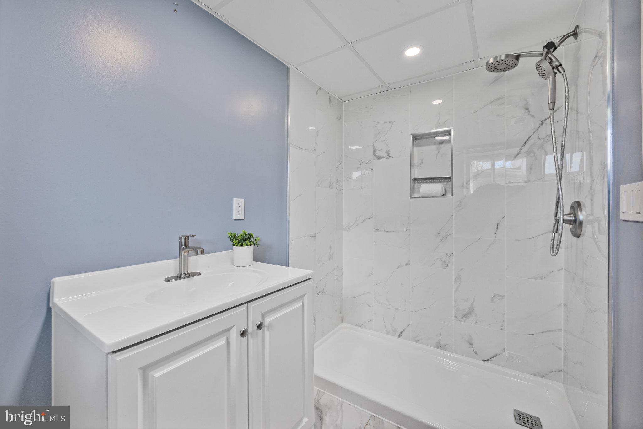 2420 West Rogers Avenue Baltimore, MD 21209 - Photo 49 of 67 a bathroom with a sink a toilet and shower