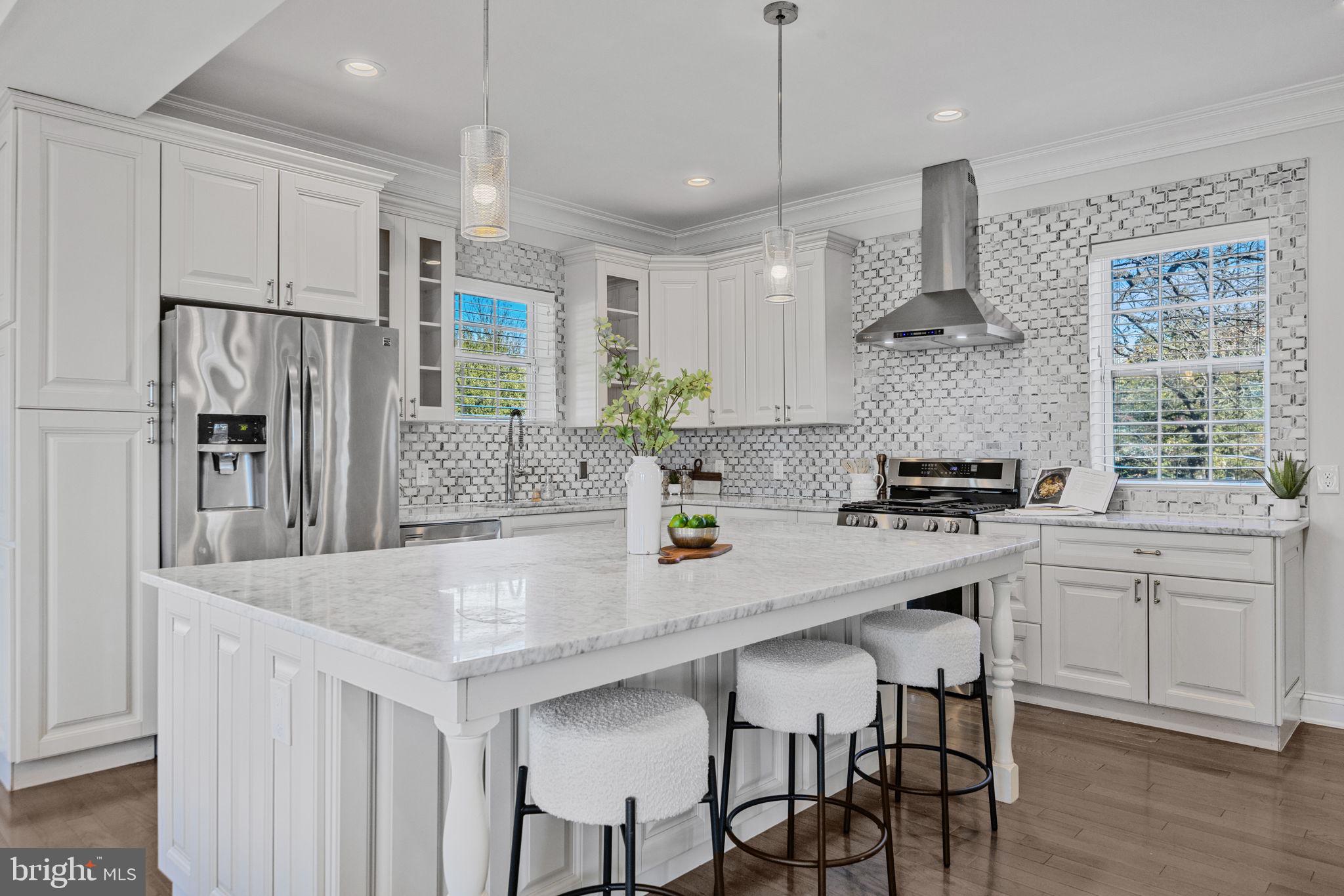 2420 West Rogers Avenue Baltimore, MD 21209 - Photo 6 of 67 a kitchen with stainless steel appliances granite countertop a sink a stove a refrigerator and island with wooden floor