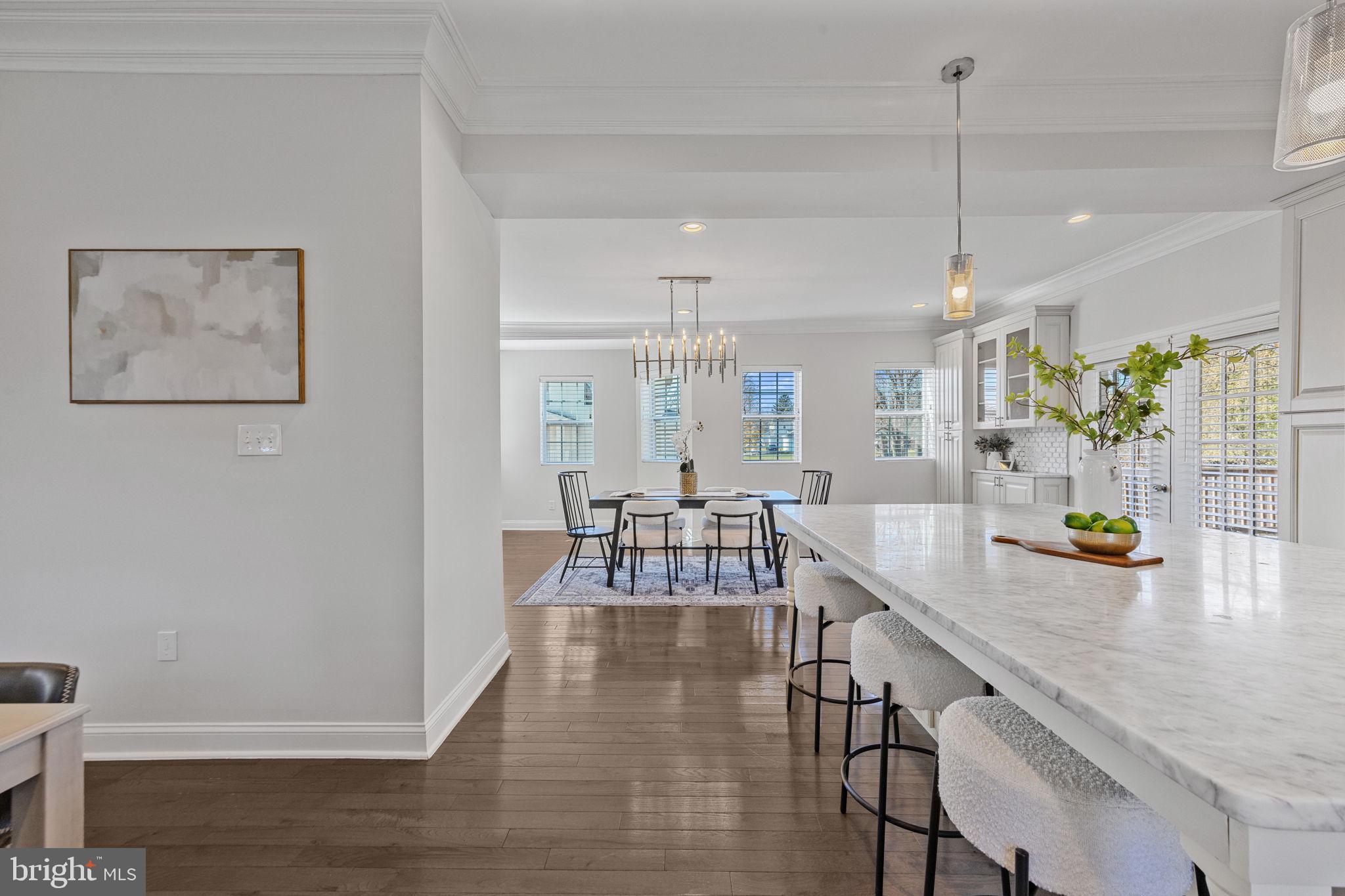 2420 West Rogers Avenue Baltimore, MD 21209 - Photo 8 of 67 a view of dining room and livingroom with furniture wooden floor a chandelier