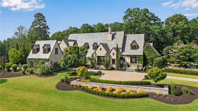 an aerial view of a house with yard swimming pool and outdoor seating