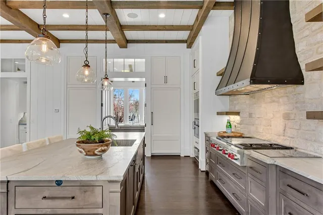 a kitchen with stainless steel appliances a sink a stove and a refrigerator