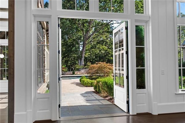 a living room with furniture and a floor to ceiling window