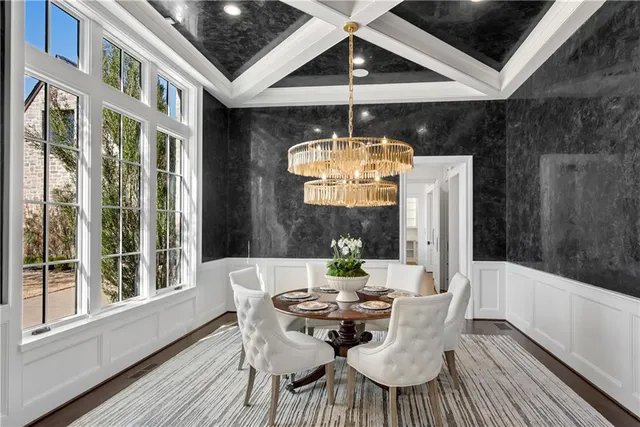 a view of a dining room with furniture wooden floor and chandelier