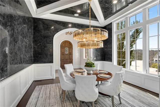 a view of a livingroom with wooden floor and stairs