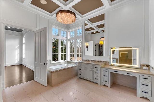 a large white kitchen with a large window