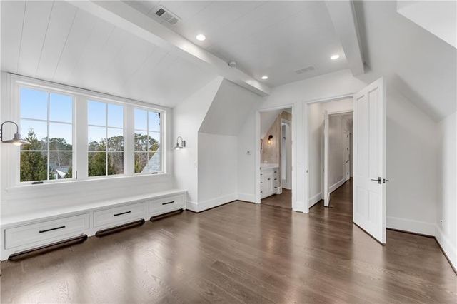 a view of a livingroom with a furniture wooden floor and chandelier