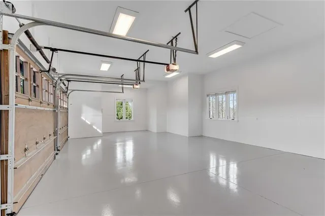 a front view of a house with a garden and trees