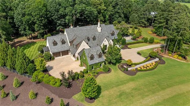 a view of a patio with table and chairs potted plants and a fire pit
