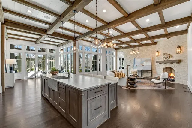 a room with stainless steel appliances granite countertop a sink and cabinets