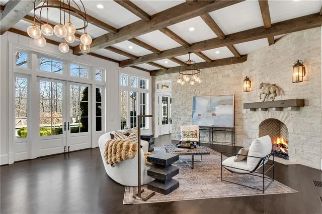 a living room with furniture a fireplace and wooden floor