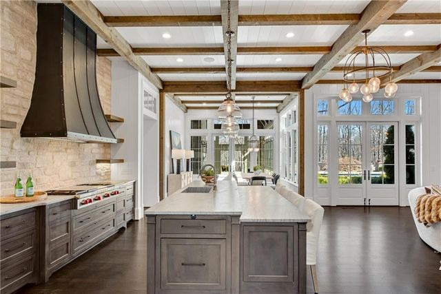 a kitchen with a large window and breakfast area