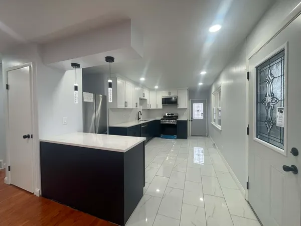 a kitchen with a sink a stove and refrigerator