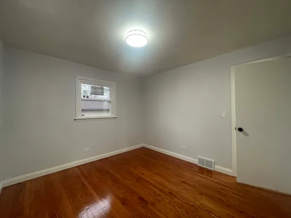 a view of hallway with wooden floor