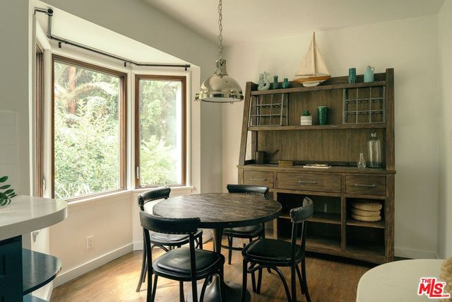a bathroom with a tub a sink a mirror and a shower