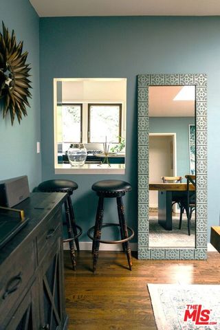 a room with furniture a dining table and a chandelier