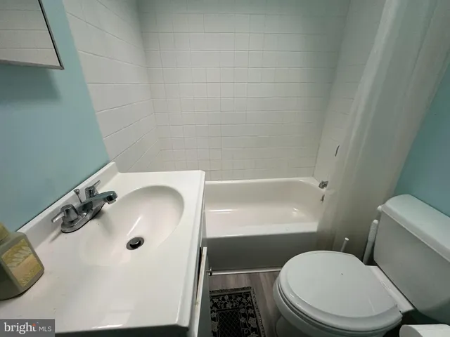 a white toilet sitting next to a bathroom sink