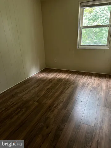 an empty room with wooden floor