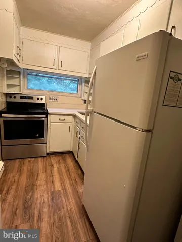 a kitchen with a refrigerator and a stove