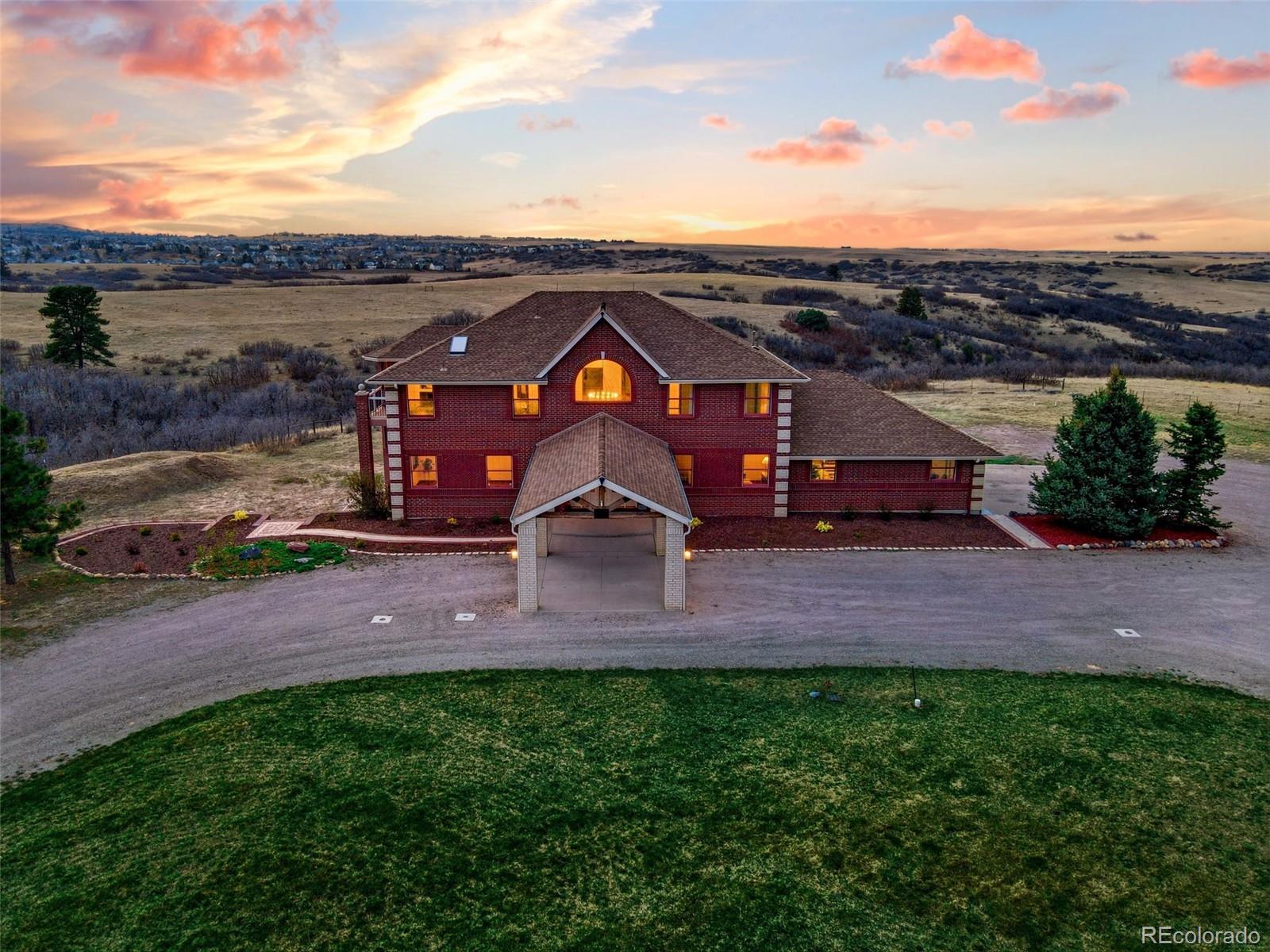 an aerial view of a house with a big yard