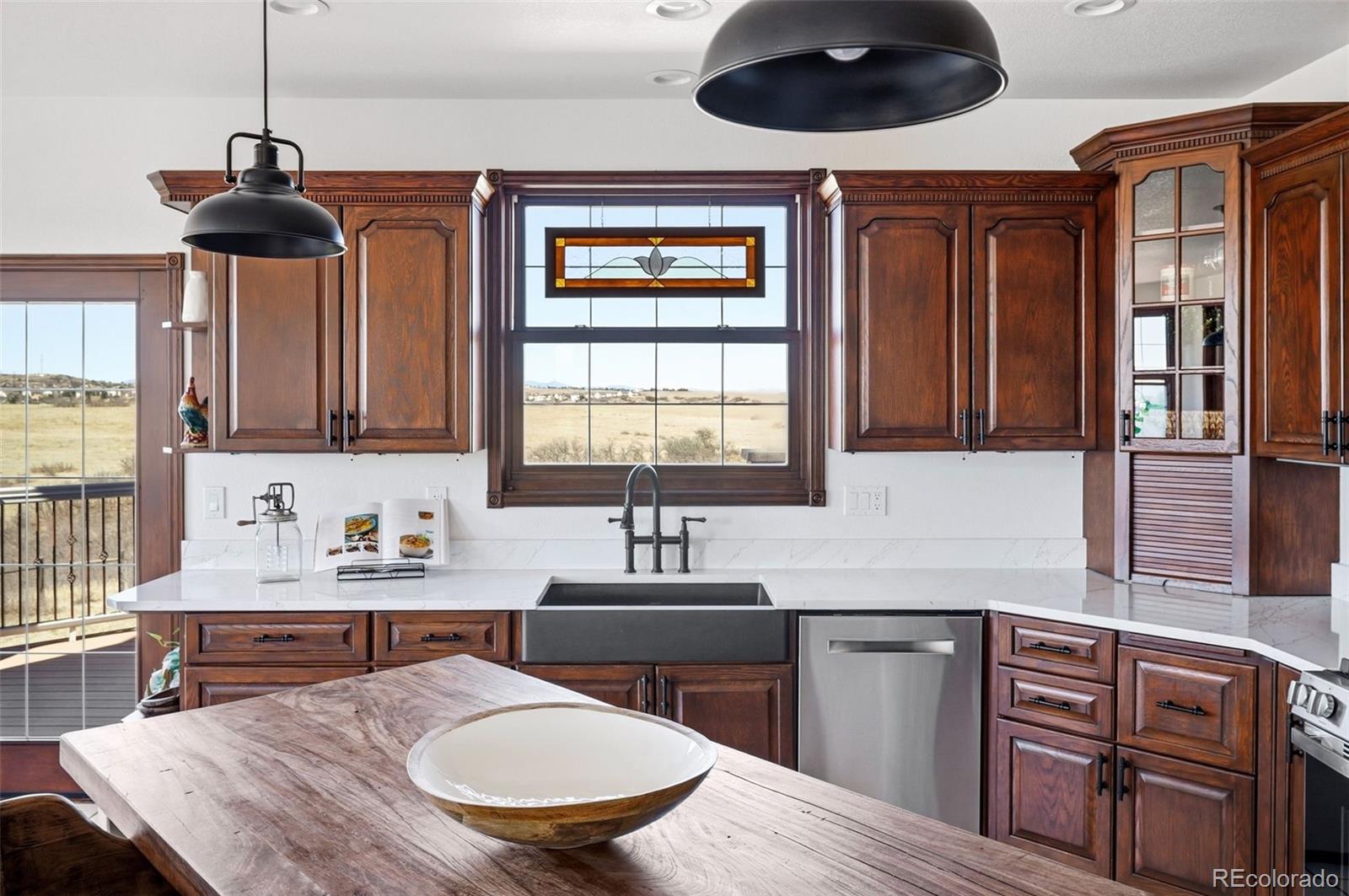 4347 Crowfoot Valley Road Castle Rock, CO 80108 - Photo 11 of 50 a kitchen with stainless steel appliances a sink stove and microwave