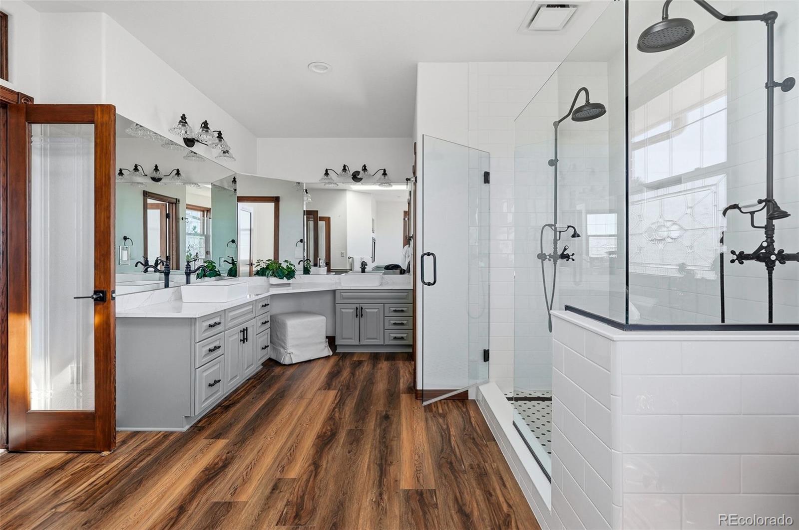4347 Crowfoot Valley Road Castle Rock, CO 80108 - Photo 20 of 50 a bathroom with a sink a mirror and a shower