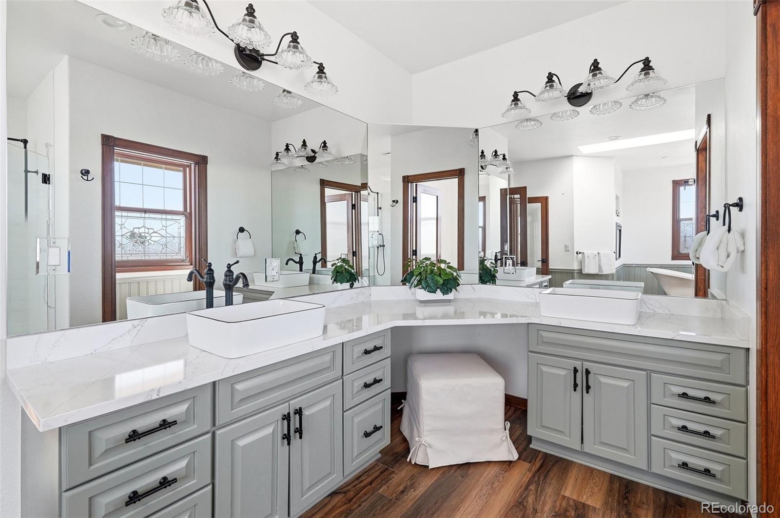 4347 Crowfoot Valley Road Castle Rock, CO 80108 - Photo 22 of 50 a spacious bathroom with a granite countertop sink and a mirror