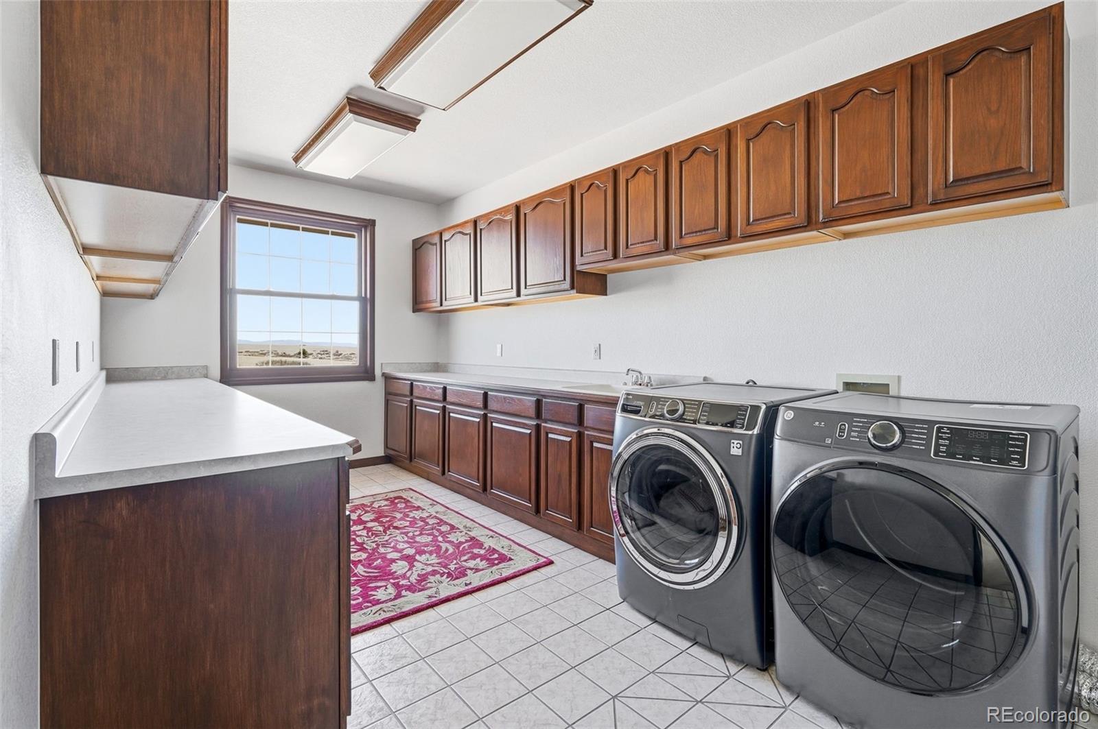 4347 Crowfoot Valley Road Castle Rock, CO 80108 - Photo 26 of 50 a utility room with dryer and washer