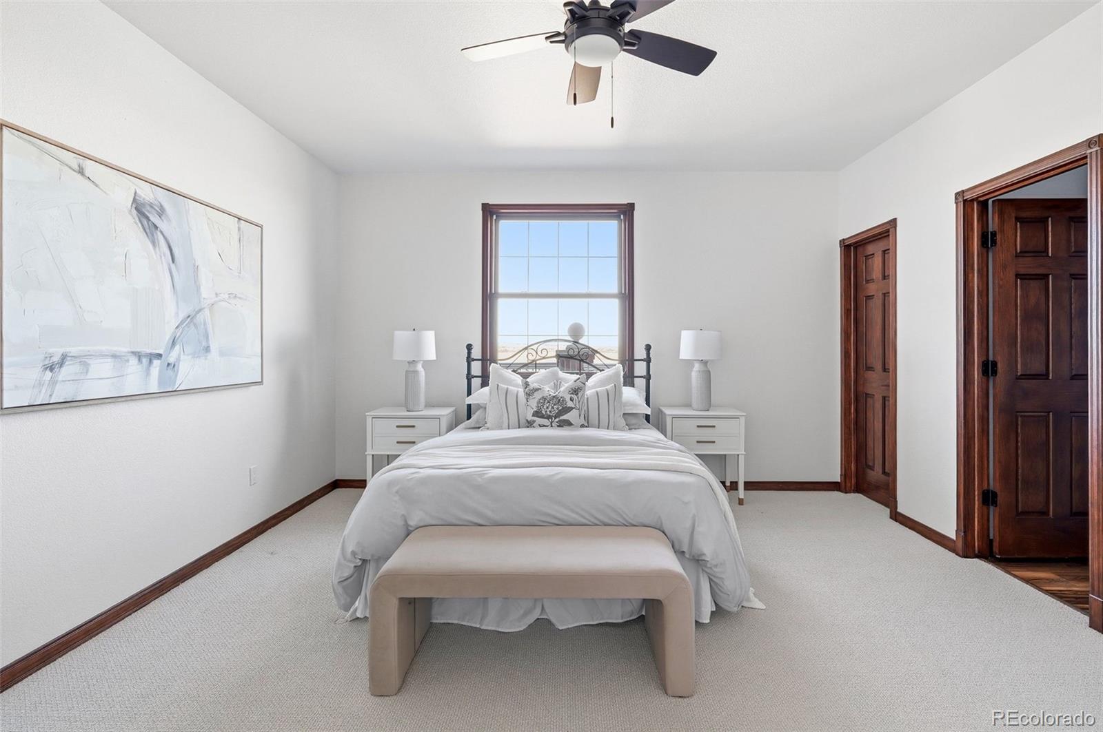 4347 Crowfoot Valley Road Castle Rock, CO 80108 - Photo 27 of 50 a spacious bedroom with a bed and window