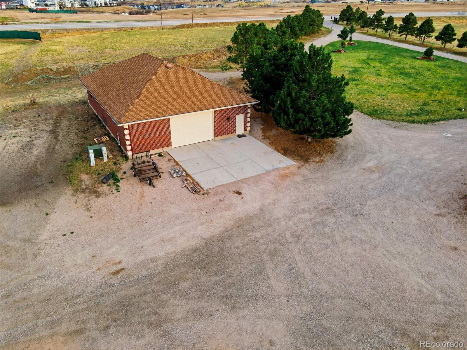 4347 Crowfoot Valley Road Castle Rock, CO 80108 - Photo 40 of 50 an aerial view of a house with a garden and lake view