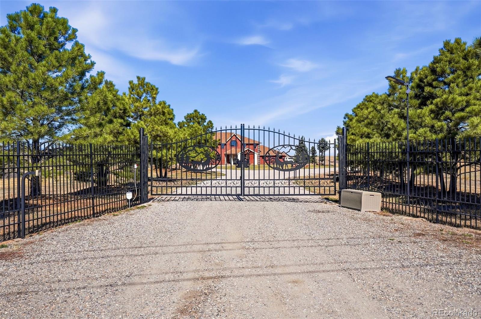 4347 Crowfoot Valley Road Castle Rock, CO 80108 - Photo 46 of 50 a view of a street with a fence and trees