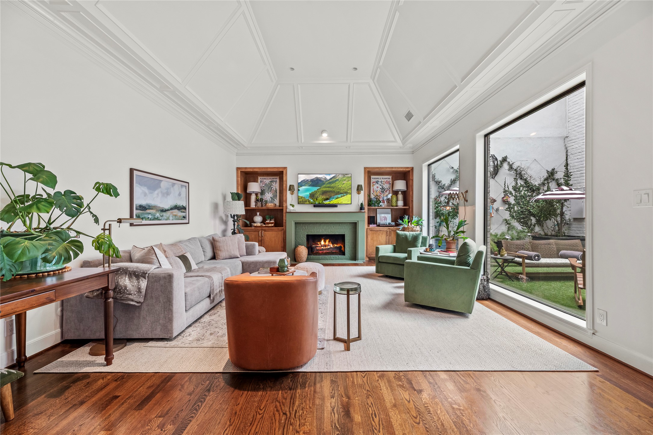 a living room with fireplace furniture and a large window