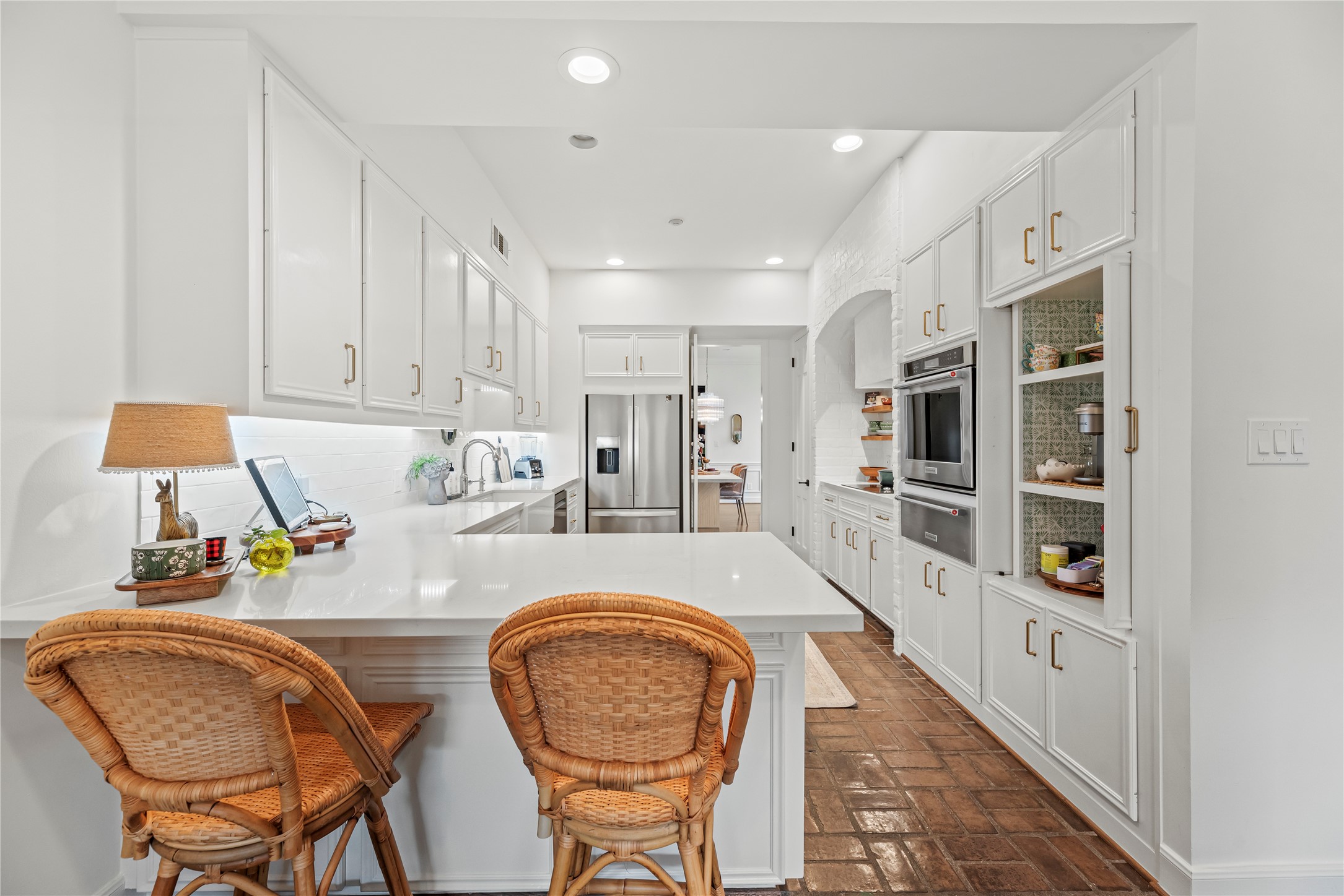 987 South Post Oak Lane Houston, TX 77056 - Photo 12 of 46 a kitchen with stainless steel appliances granite countertop a sink and a refrigerator