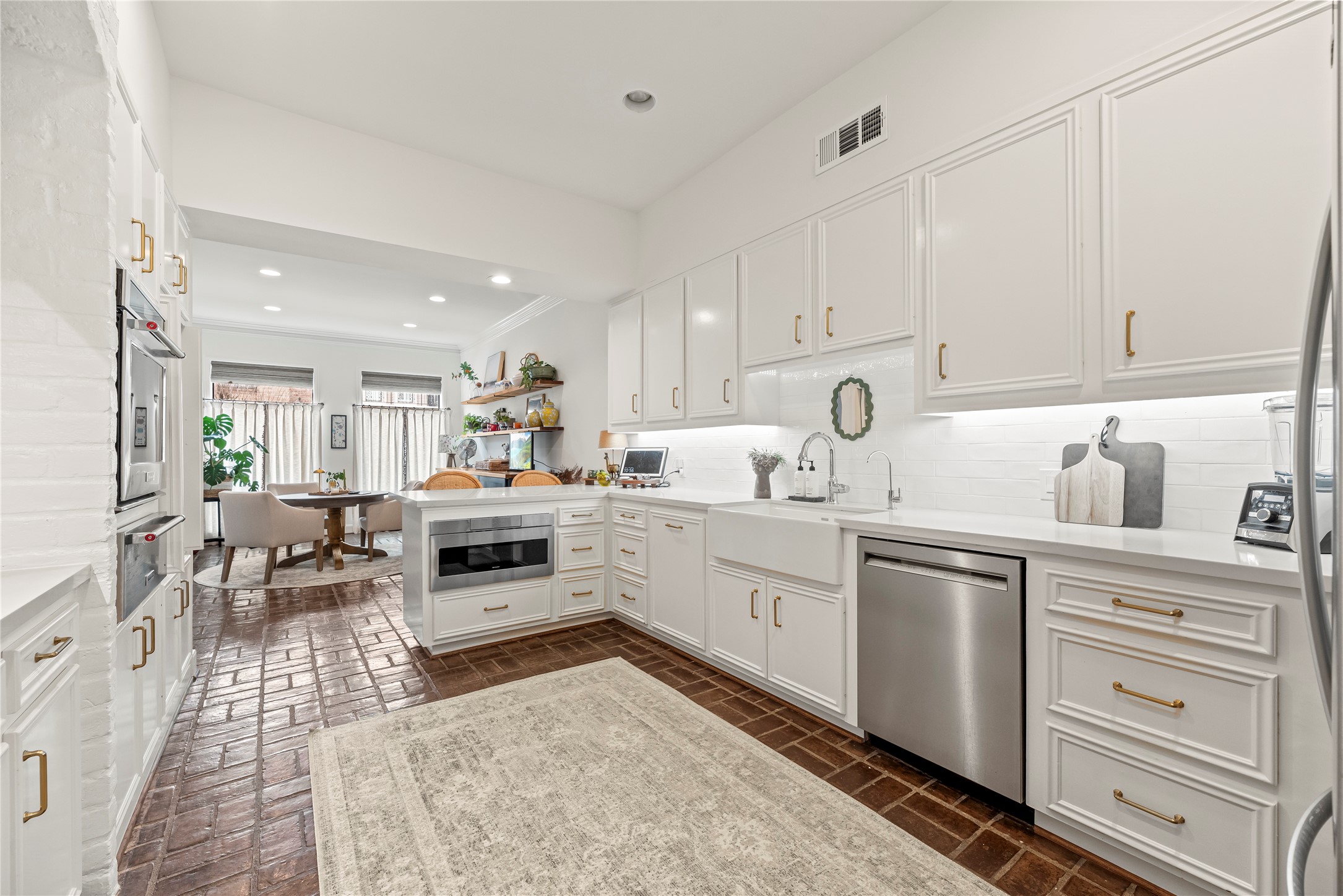 987 South Post Oak Lane Houston, TX 77056 - Photo 10 of 46 a kitchen with white cabinets and white appliances