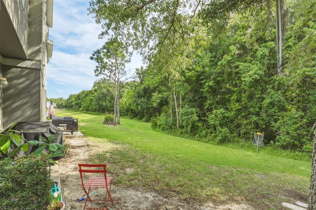 6458 South Goldenrod Road, Unit 29B Orlando, FL 32822 - Photo 27 of 40 a view of a chair and table in the garden