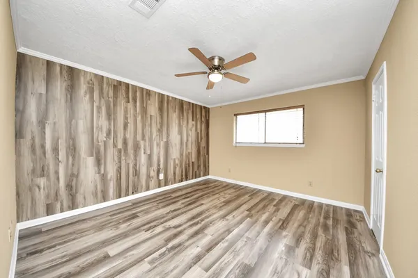 a view of a room with a window and a ceiling fan