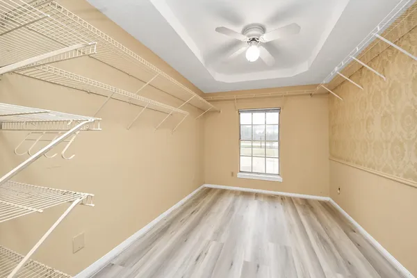 a view of a room with a ceiling fan and a window