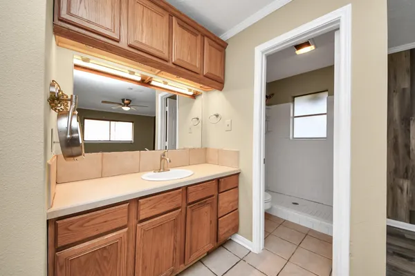a spacious bathroom with a granite countertop sink and mirror