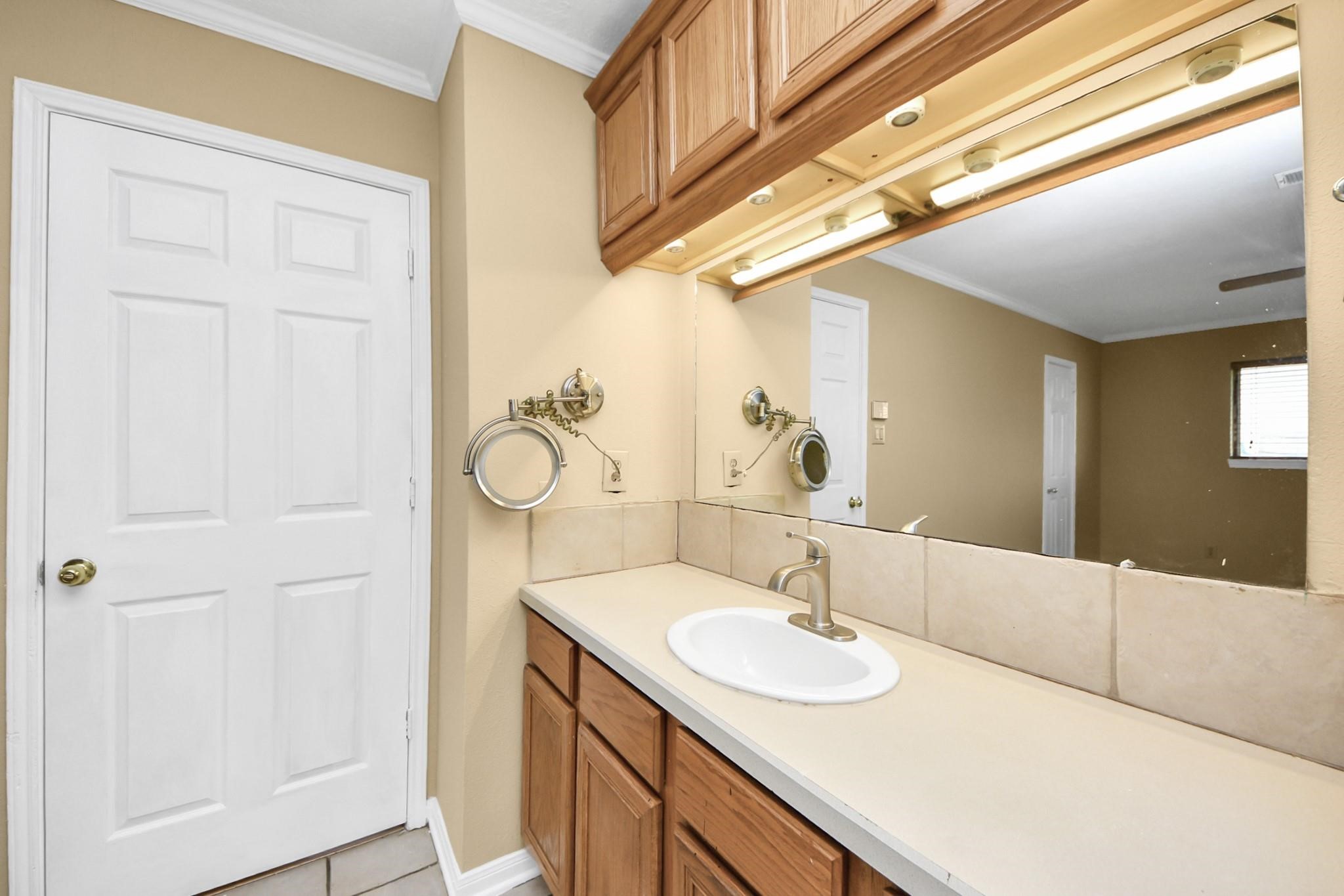 13610 Furman Road Houston, TX 77047 - Photo 18 of 25 a bathroom with a sink and a mirror
