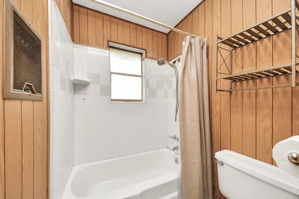 a bathroom with a toilet a sink and bathtub