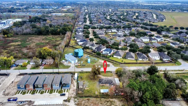 an aerial view of residential houses with outdoor space