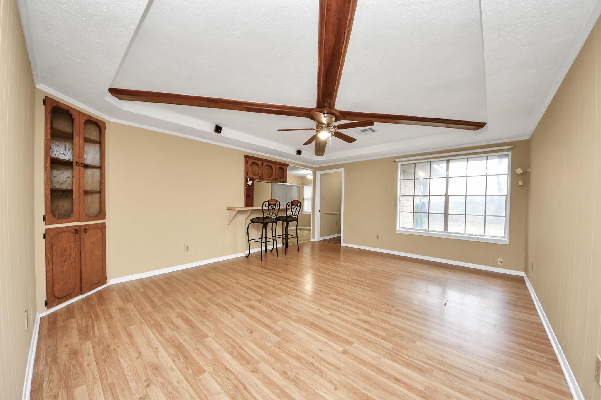 13610 Furman Road Houston, TX 77047 - Photo 7 of 25 a view of an empty room with wooden floor and a window