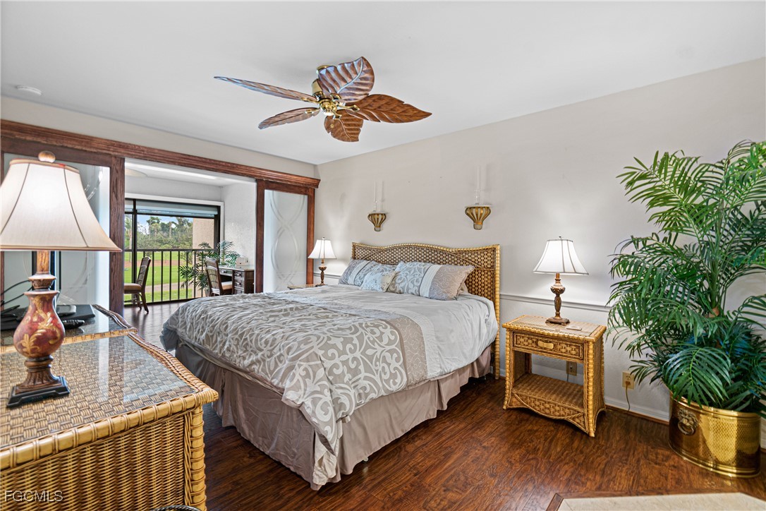5905 Trailwinds Drive, Unit 824 Fort Myers, FL 33907 - Photo 11 of 50 a bedroom with bed and a chandelier