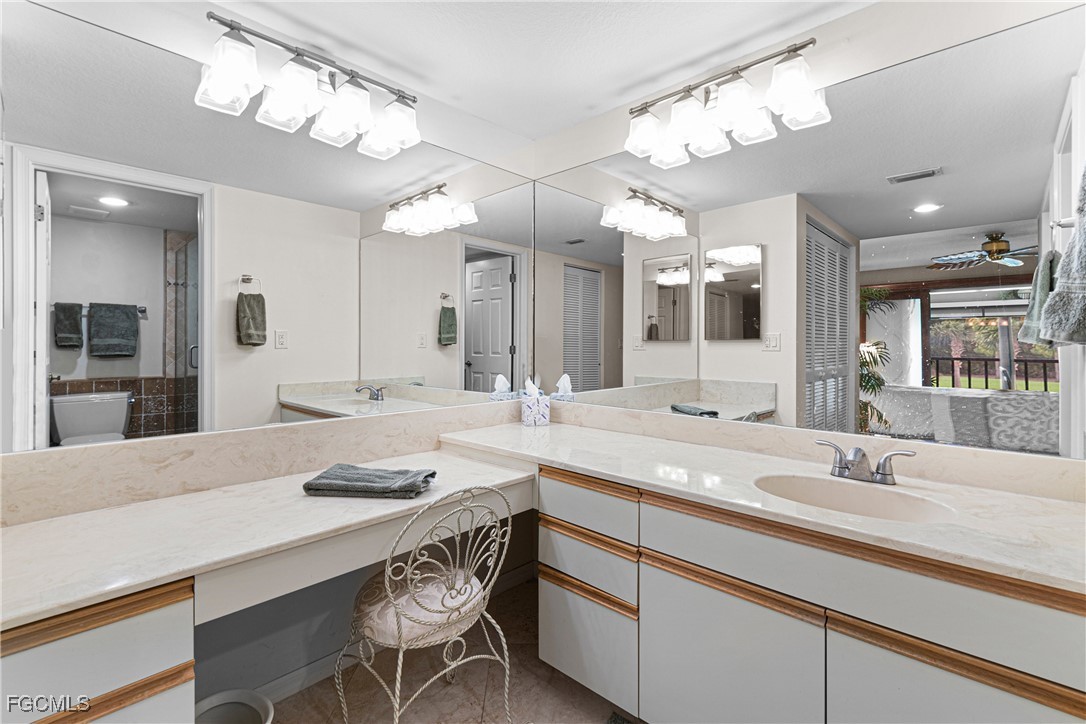 5905 Trailwinds Drive, Unit 824 Fort Myers, FL 33907 - Photo 14 of 50 a kitchen with a sink and chandelier