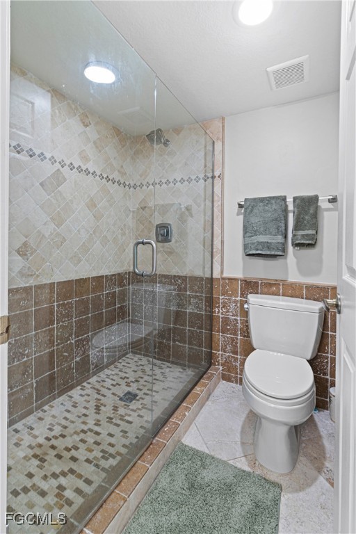 5905 Trailwinds Drive, Unit 824 Fort Myers, FL 33907 - Photo 15 of 50 a bathroom with a toilet and a shower
