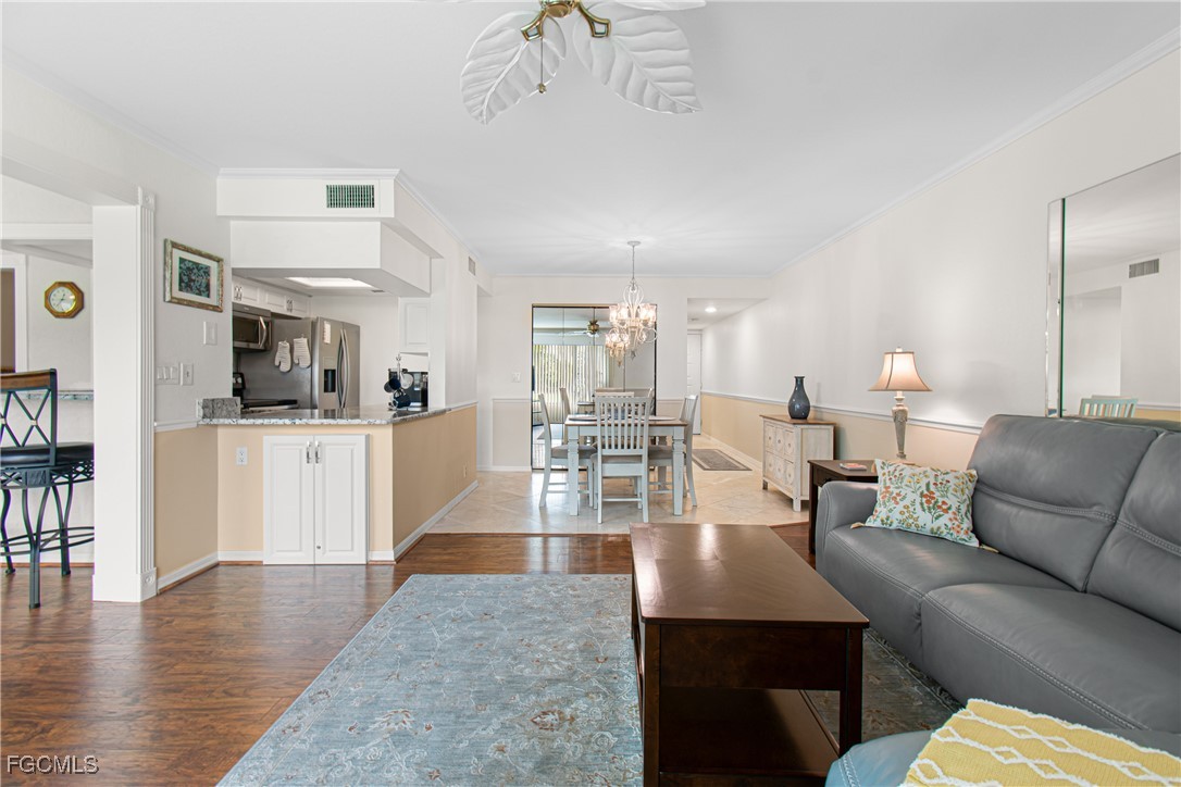 5905 Trailwinds Drive, Unit 824 Fort Myers, FL 33907 - Photo 25 of 50 a living room with furniture and kitchen view