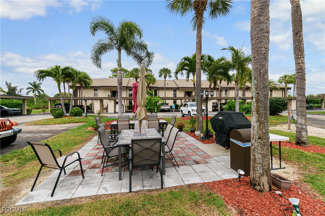 5905 Trailwinds Drive, Unit 824 Fort Myers, FL 33907 - Photo 49 of 50 a view of a chairs and table in patio