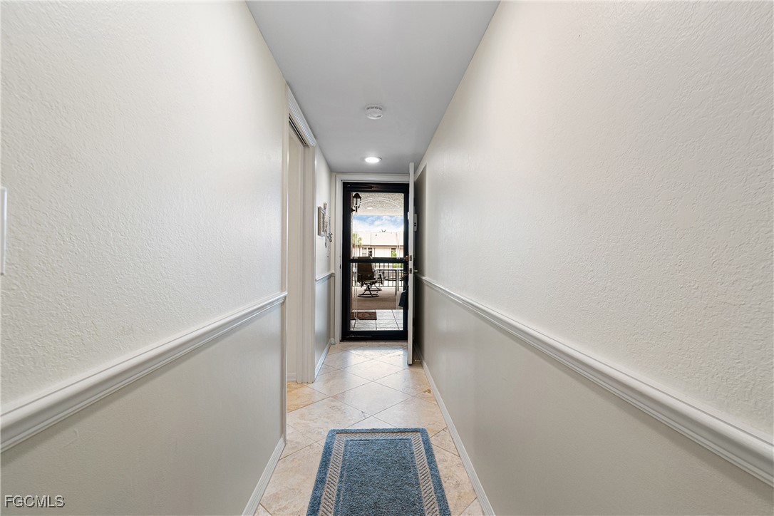 5905 Trailwinds Drive, Unit 824 Fort Myers, FL 33907 - Photo 5 of 50 a view of hallway with stairs