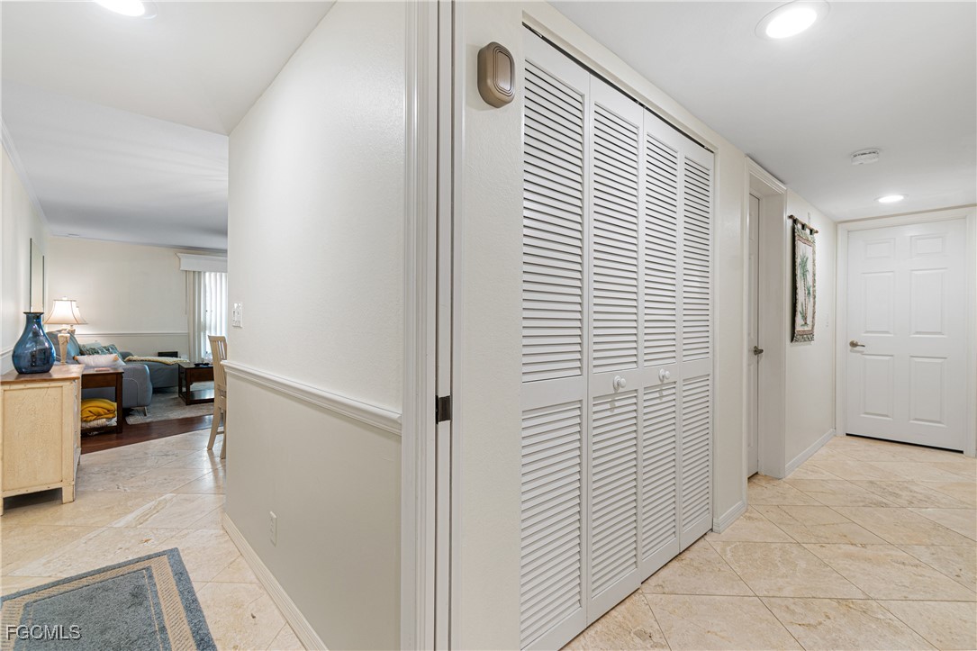 5905 Trailwinds Drive, Unit 824 Fort Myers, FL 33907 - Photo 6 of 50 a view of a hallway and a livingroom with furniture
