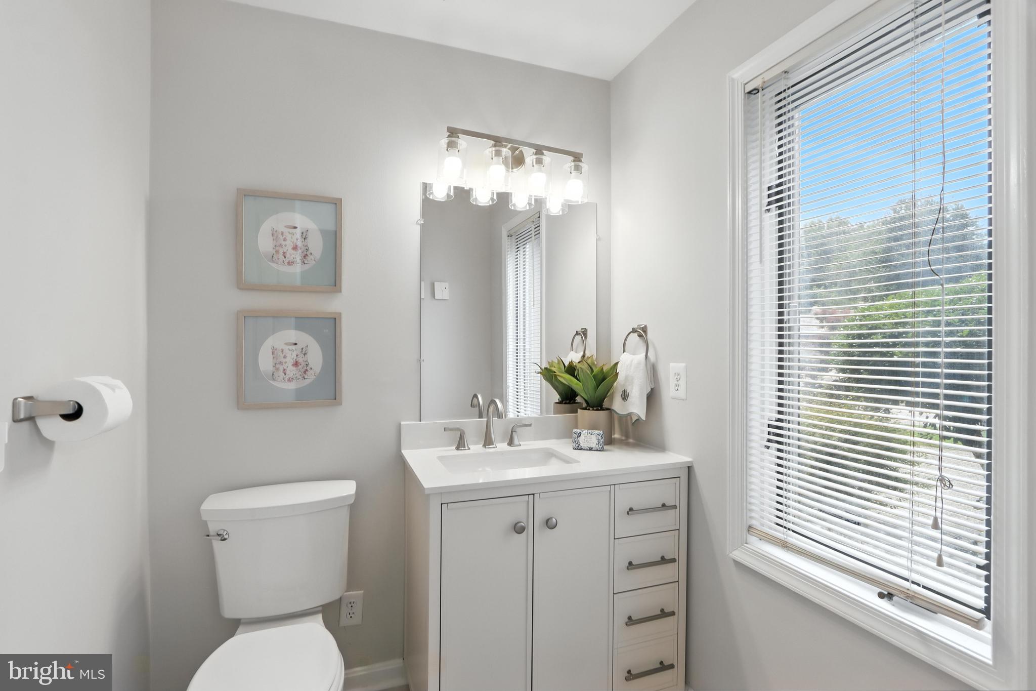 3005 Courtside Road Bowie, MD 20721 - Photo 12 of 43 a bathroom with a toilet sink and mirror